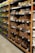 Shelves in a grocery store are stocked with various packaged food items. The left side features a range of cooking oils, while the right side displays a selection of baked goods or packaged snacks. Each shelf is orderly, with products neatly arranged in rows and labels visible for pricing.