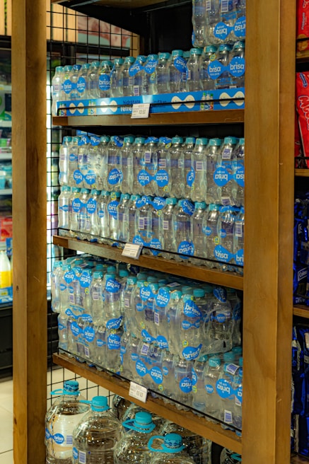 Close-up of fresh water bottles neatly arranged on shelves inside Raspersil warehouse