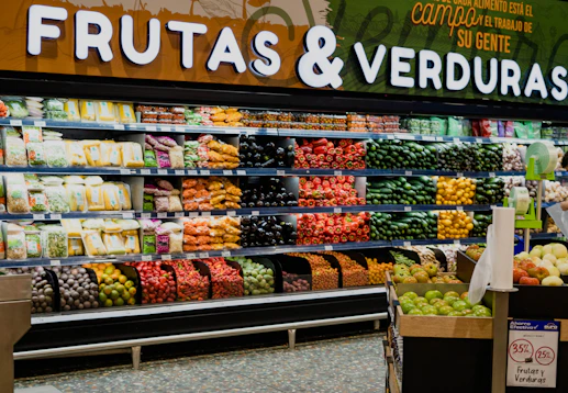 a produce section of a grocery store filled with fruits and veggies