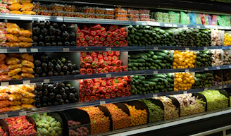 a display in a grocery store filled with lots of fruits and vegetables