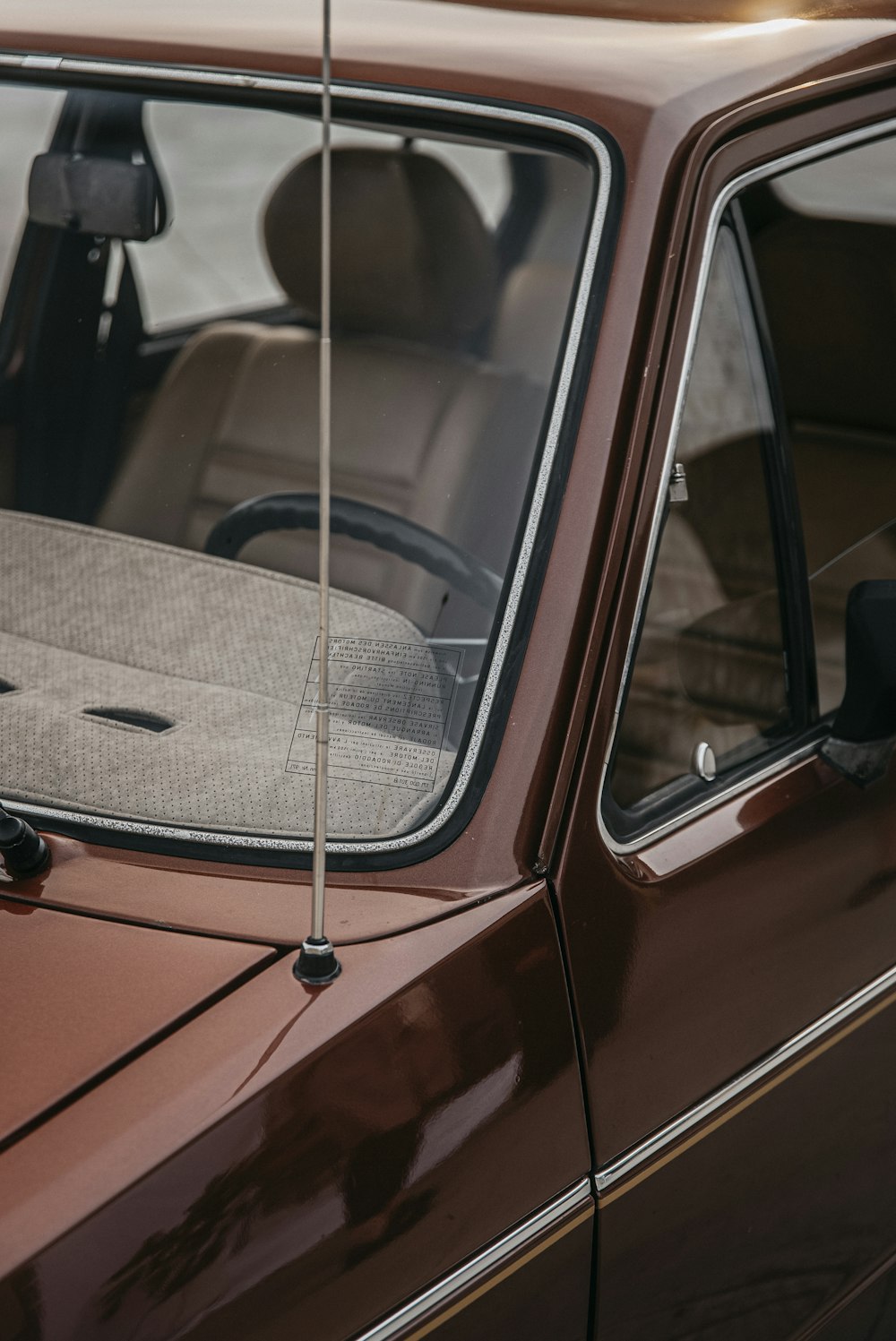 a brown car with a steering wheel and a seat belt