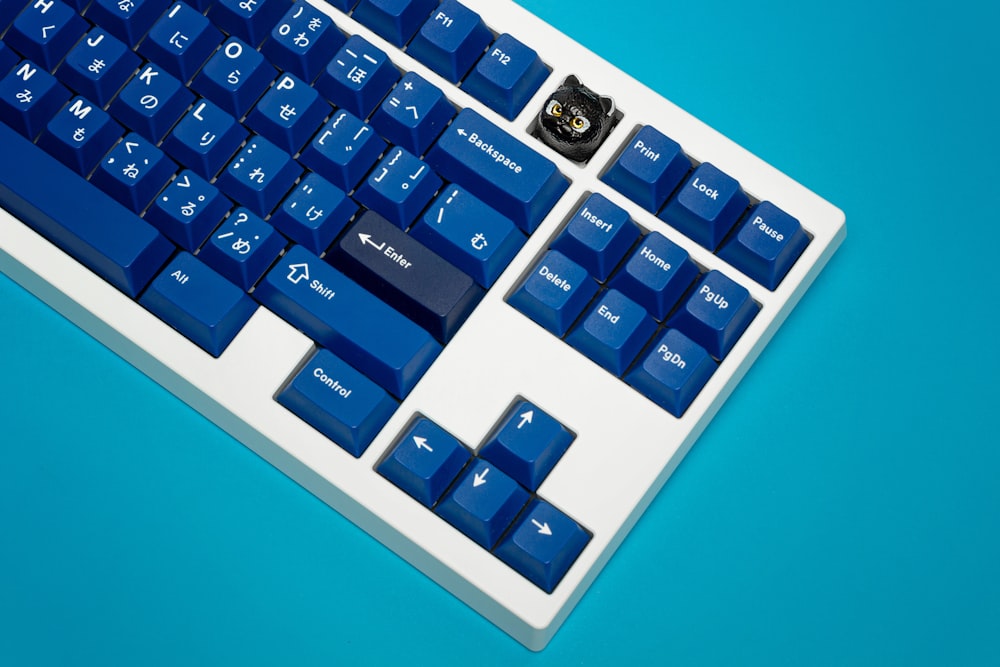 Un teclado de computadora azul y blanco sobre un fondo azul