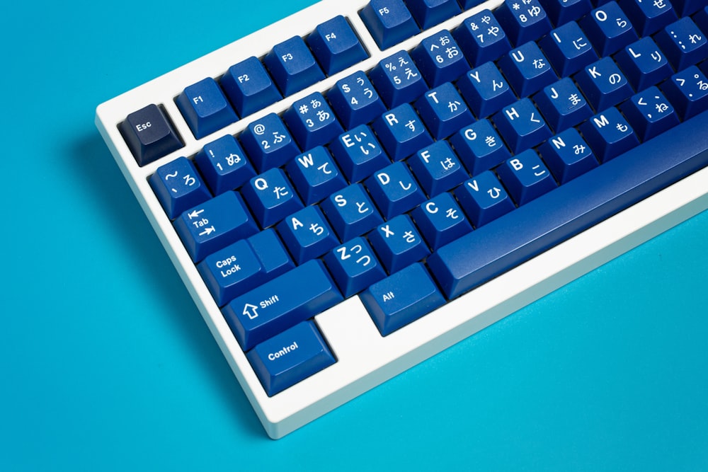 a blue and white keyboard on a blue surface