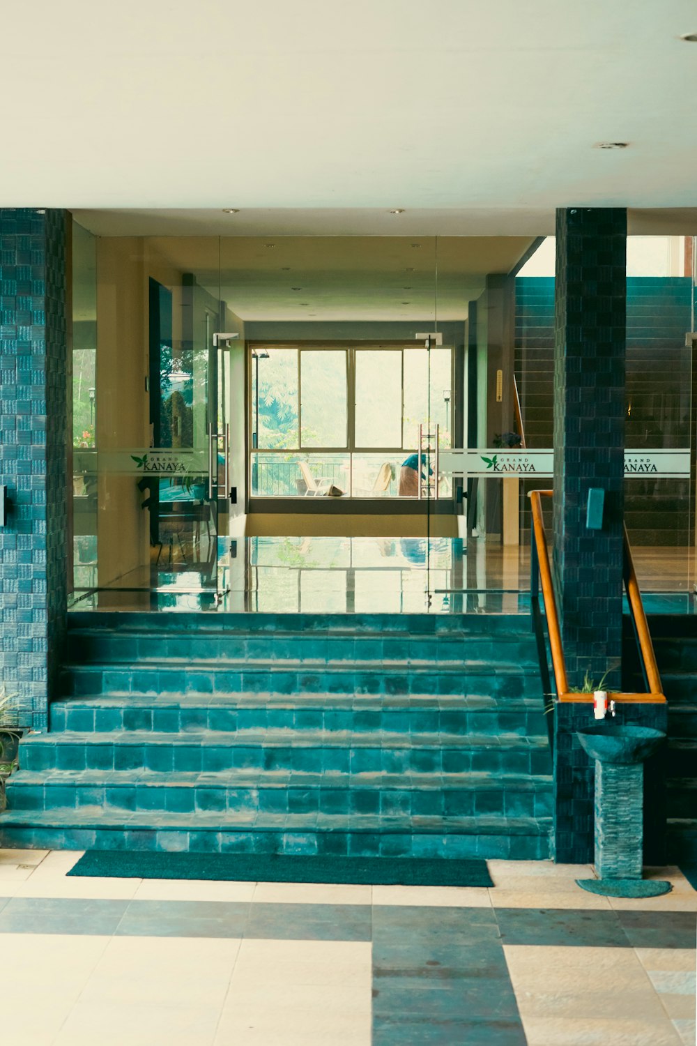 a set of blue steps leading to a lobby