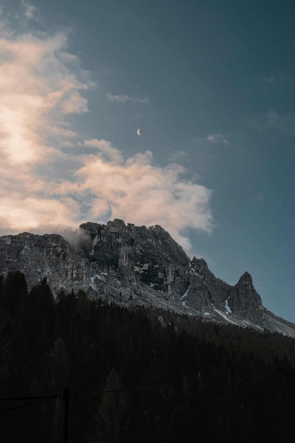 a mountain with a few clouds in the sky