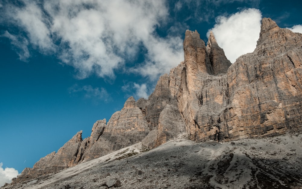 a very tall mountain with some clouds in the sky