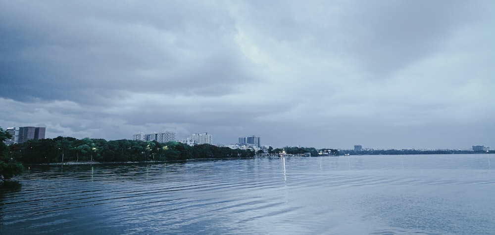 a body of water with a city in the background