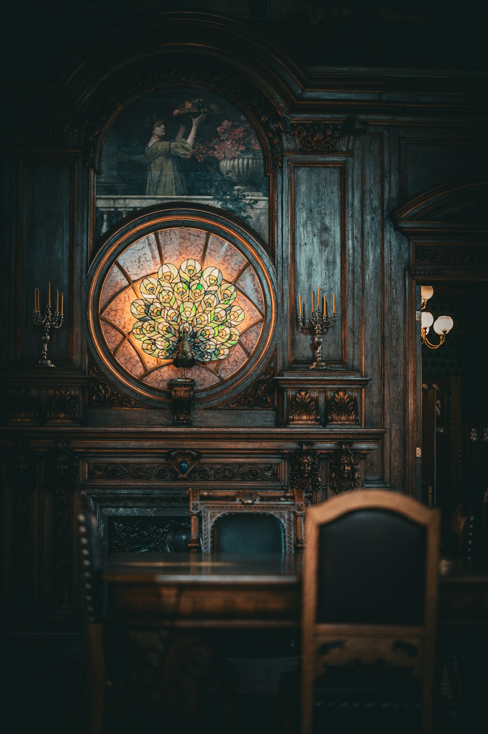 a dining room table with a stained glass window