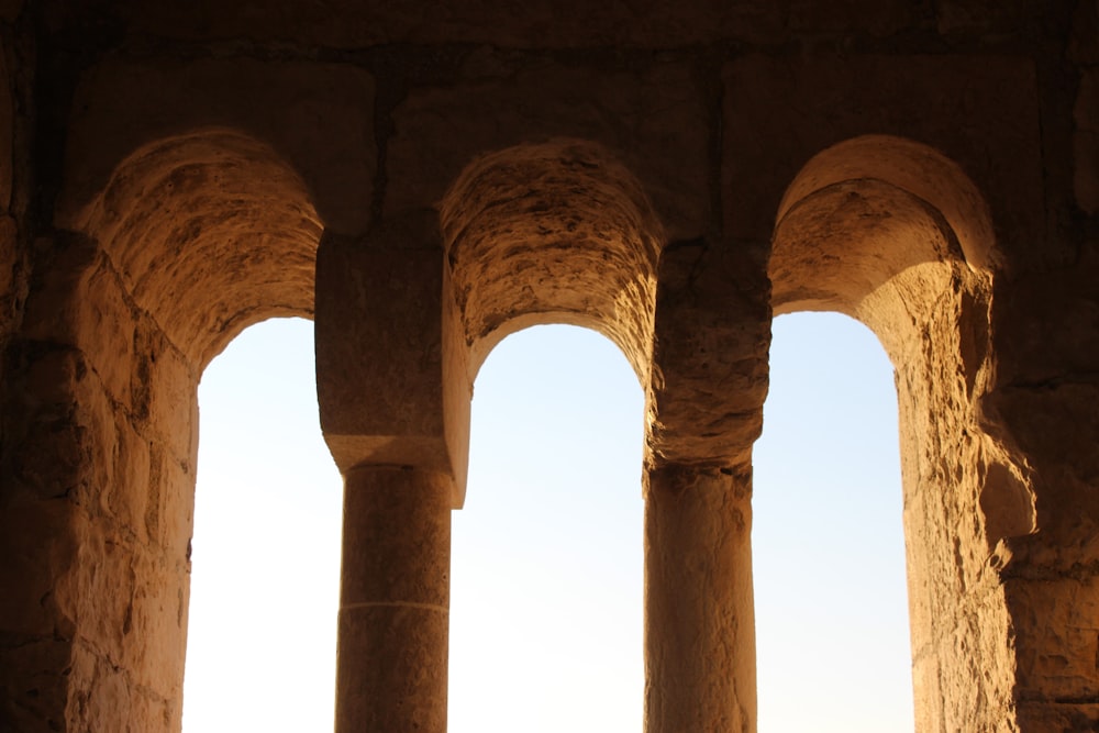 a row of stone pillars in a stone building