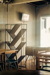 Cozy cafe interior with bookshelves and warm lighting.