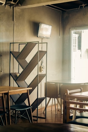 Cozy cafe interior with bookshelves and warm lighting.
