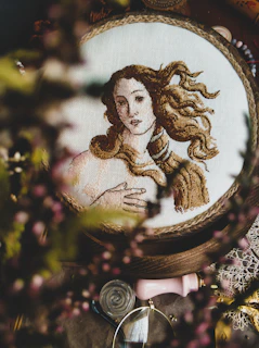 Artisan Emily Seymour working on a detailed embroidery hoop in her studio