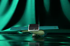 A modern smart watch from Mont Royal displayed on a minimalist black stand with soft golden lighting.