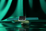 Smartwatch with glowing screen resting on a smooth stone surface