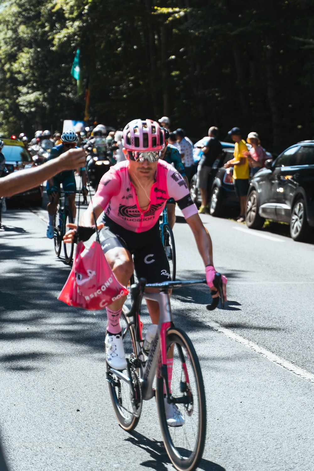 a woman riding a bike down a street