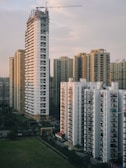 a group of tall buildings with a crane in the background