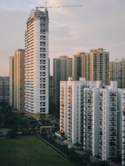 a group of tall buildings with a crane in the background