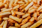 a pile of french fries sitting on top of a table