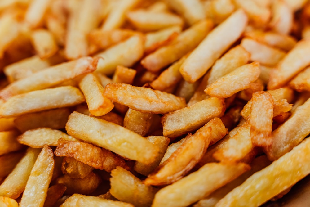 a pile of french fries sitting on top of a table