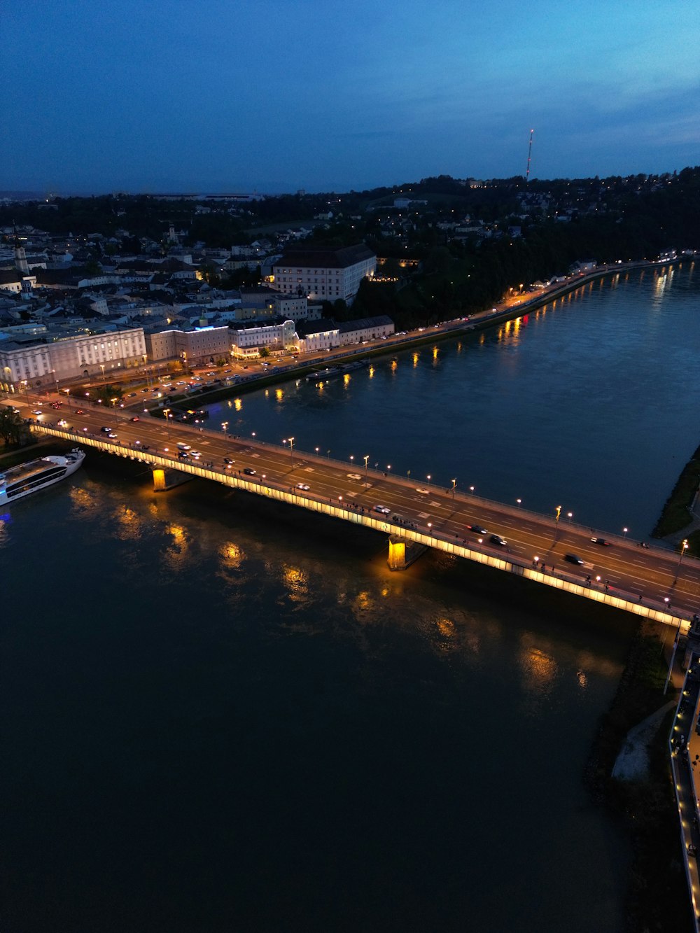an aerial view of a bridge over a river at night