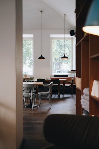 Cozy interior of domuss café with warm lighting and minimalist decor.