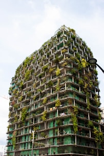 a very tall building with lots of plants growing on it