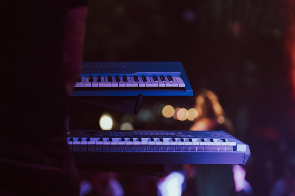 a close up of a keyboard with a person in the background