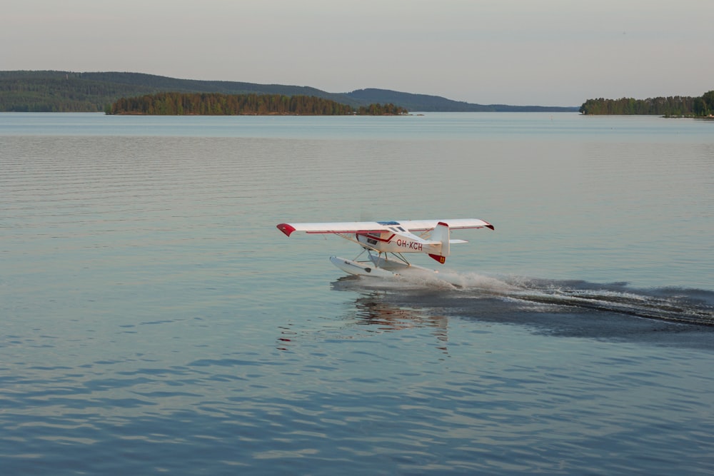 a small plane is flying low over the water