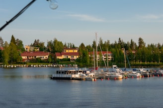 A peaceful waterfront view of Fairfield Harbour with boats docked and homes lining the shore.