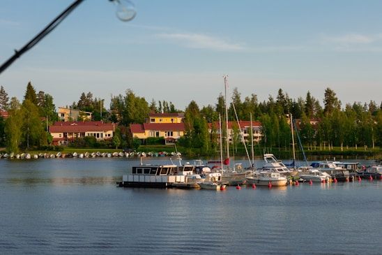 A peaceful waterfront view of Fairfield Harbour with boats docked and homes lining the shore.