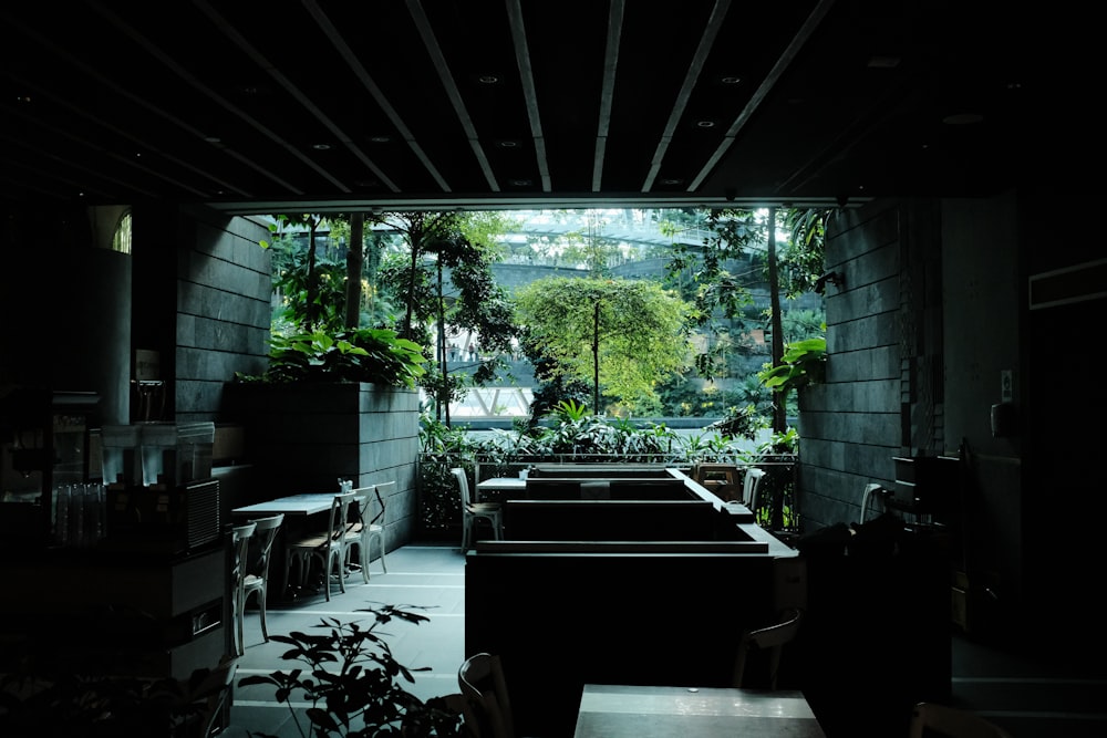 a dimly lit room with tables and chairs