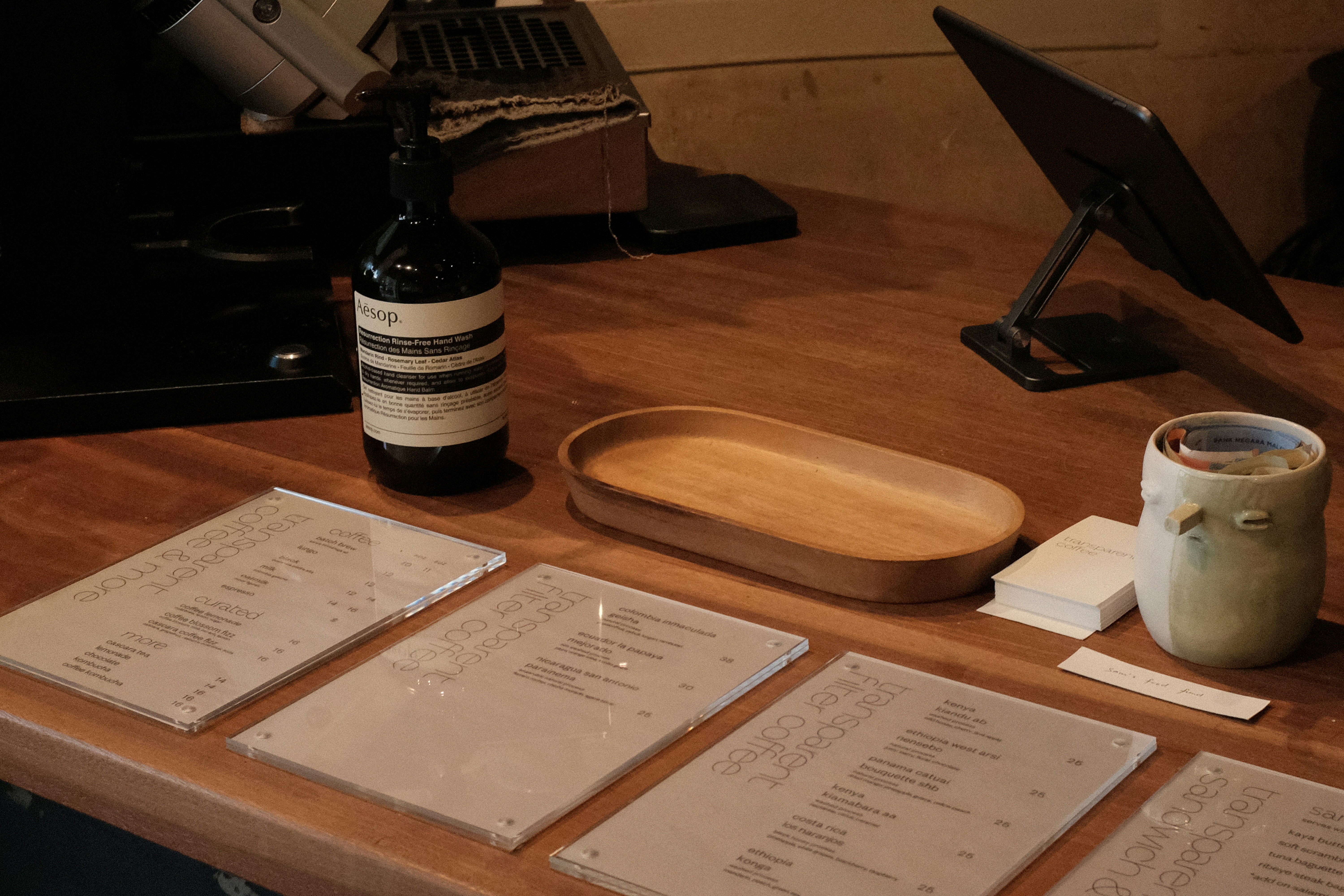 Wooden table with menus and wine bottle