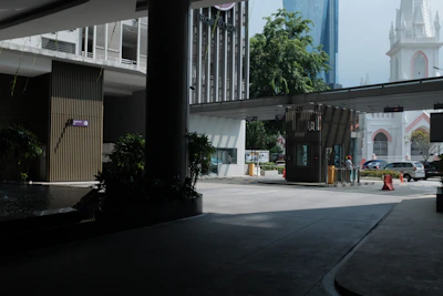 Secure gated entrance with a modern access booth and perimeter wall.