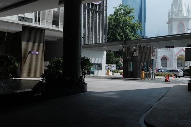 A sleek automatic boom barrier installed at a modern parking entrance.