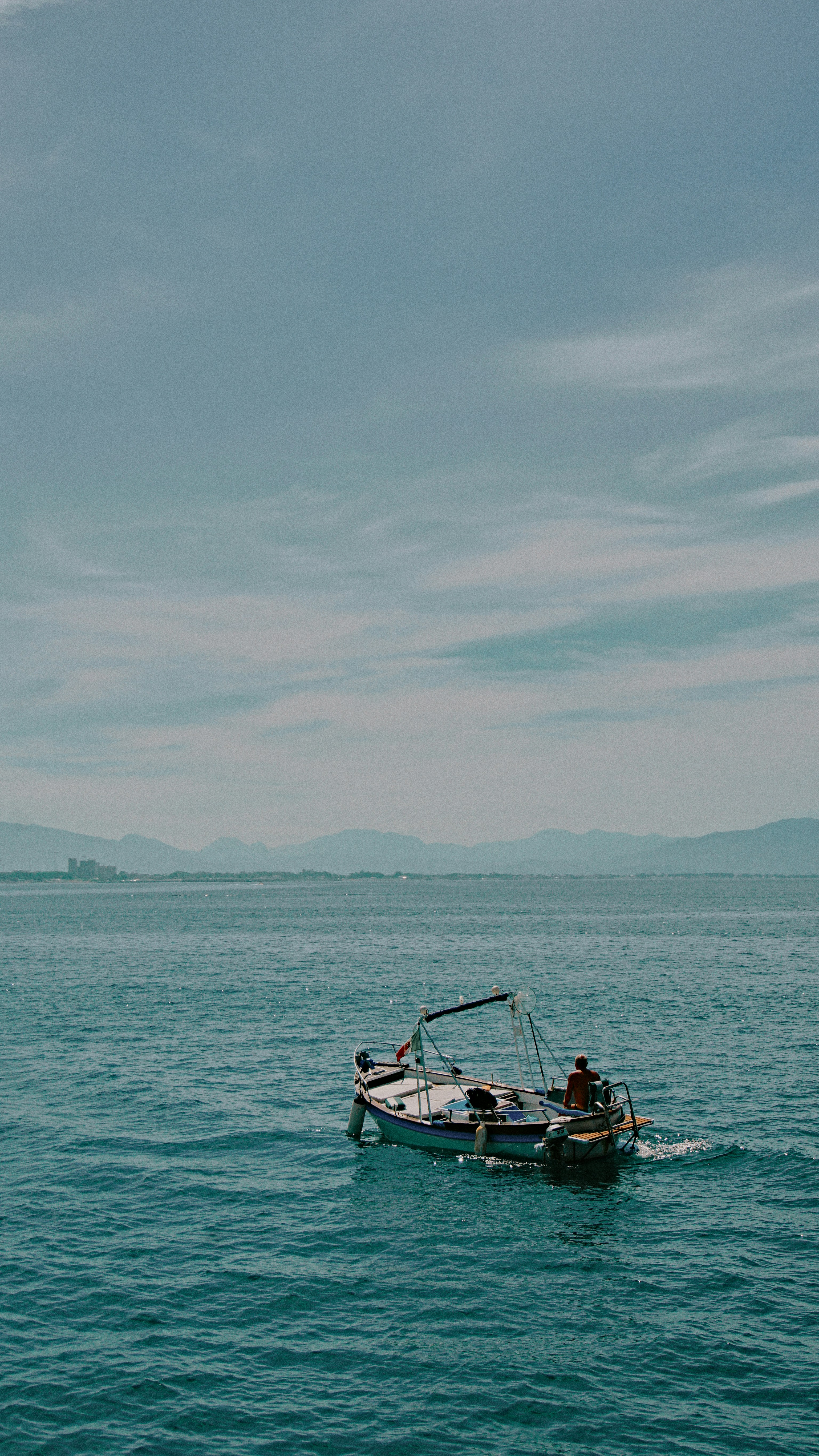 a small boat in the middle of a large body of water