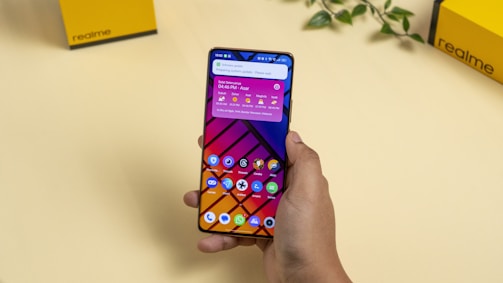 a person holding a cell phone in their hand