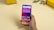 A hand holding a smartphone displaying a colorful home screen with various app icons against a geometric background. The screen shows a time, date, weather widget, and notifications. In the background, there are yellow boxes with 'realme' branding and a small plant on a beige surface.
