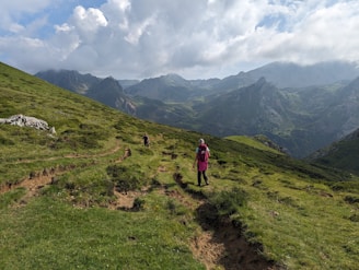 Couple hiking through lush green mountains with panoramic views