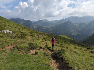 A couple hiking on a scenic trail with panoramic valley views
