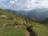A scenic view of two friends hiking on a mountain trail.