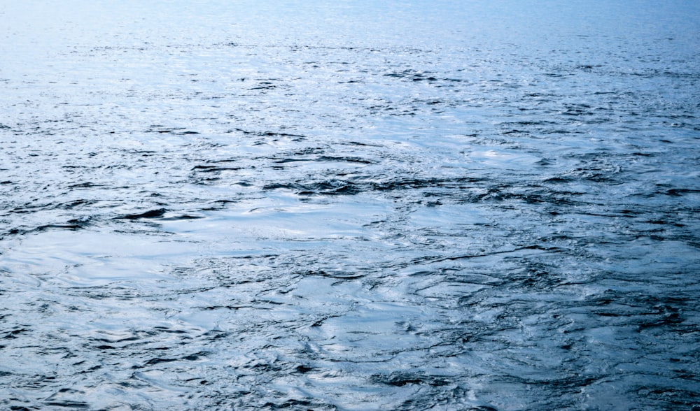 a large body of water with a boat in the distance