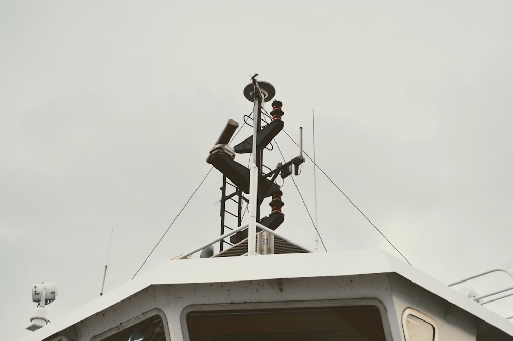 the top of a boat with a weather vane on it