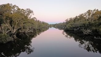 A serene sunrise over a tranquil river, symbolizing the sacred gift of life and divine grace.