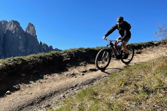 Mountain biker riding along a rugged trail overlooking the Andes foothills