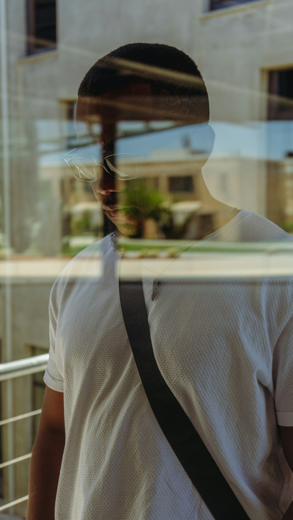 a man standing in front of a glass window