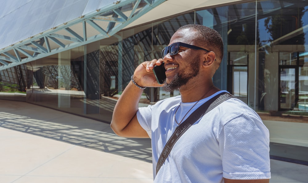 a man talking on a cell phone while wearing sunglasses