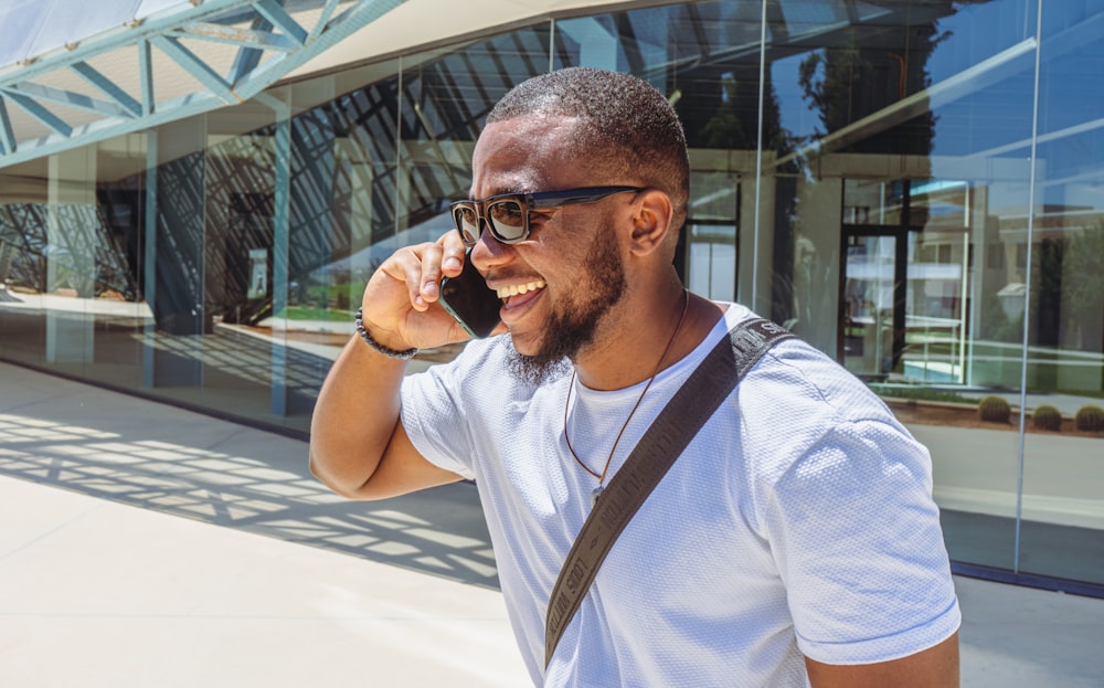 a man talking on a cell phone while wearing sunglasses