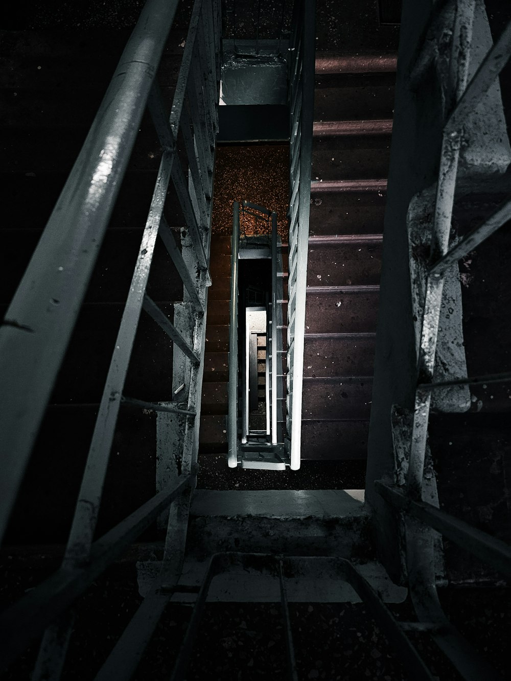 a dark hallway with stairs leading to a door