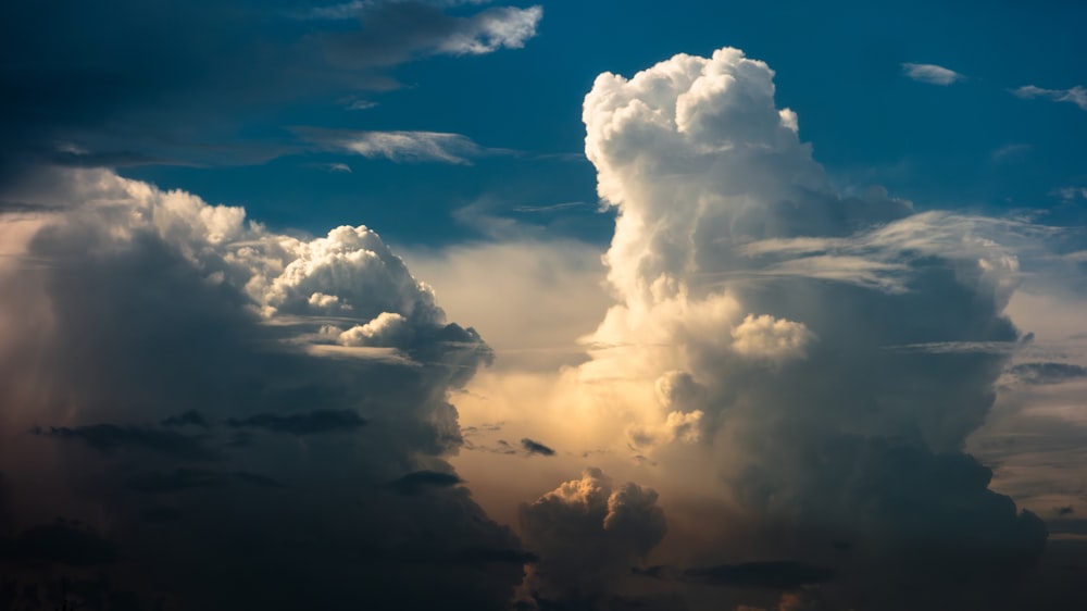 a large cloud is in the sky above a city