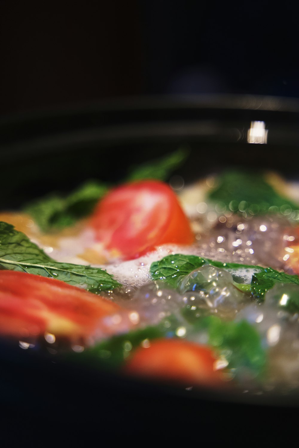 a close up of a pan of food with tomatoes and spinach
